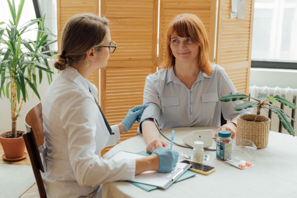 a doctor checking a patient s blood pressure